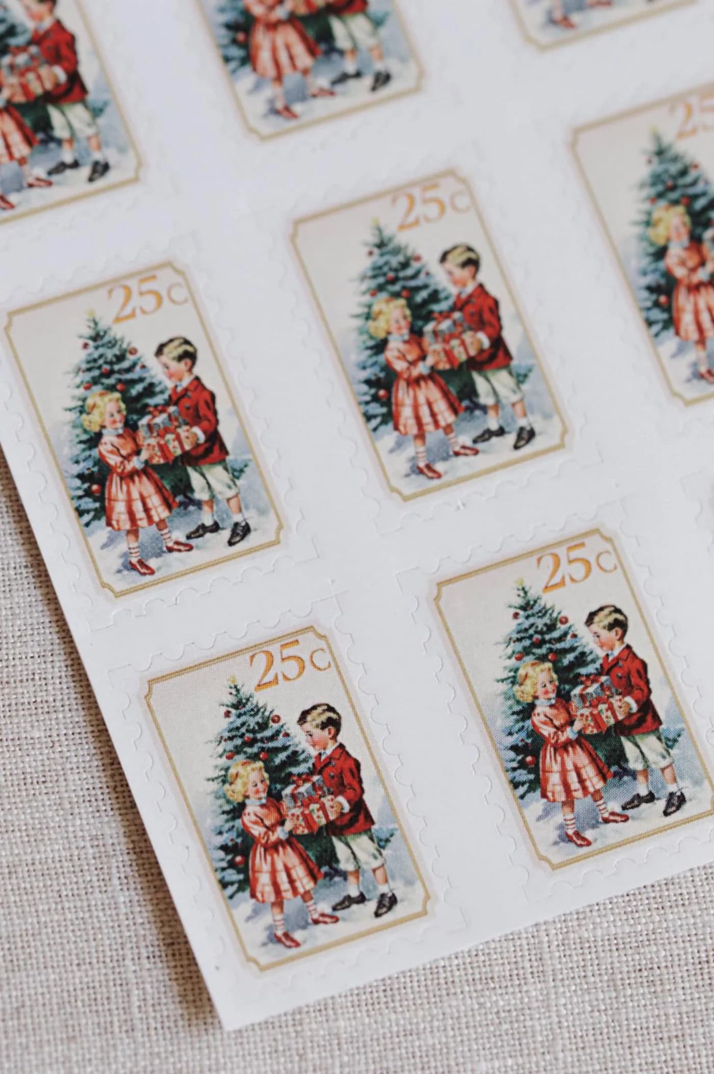 Printed decorative stamps illustrating children carrying a Christmas tree