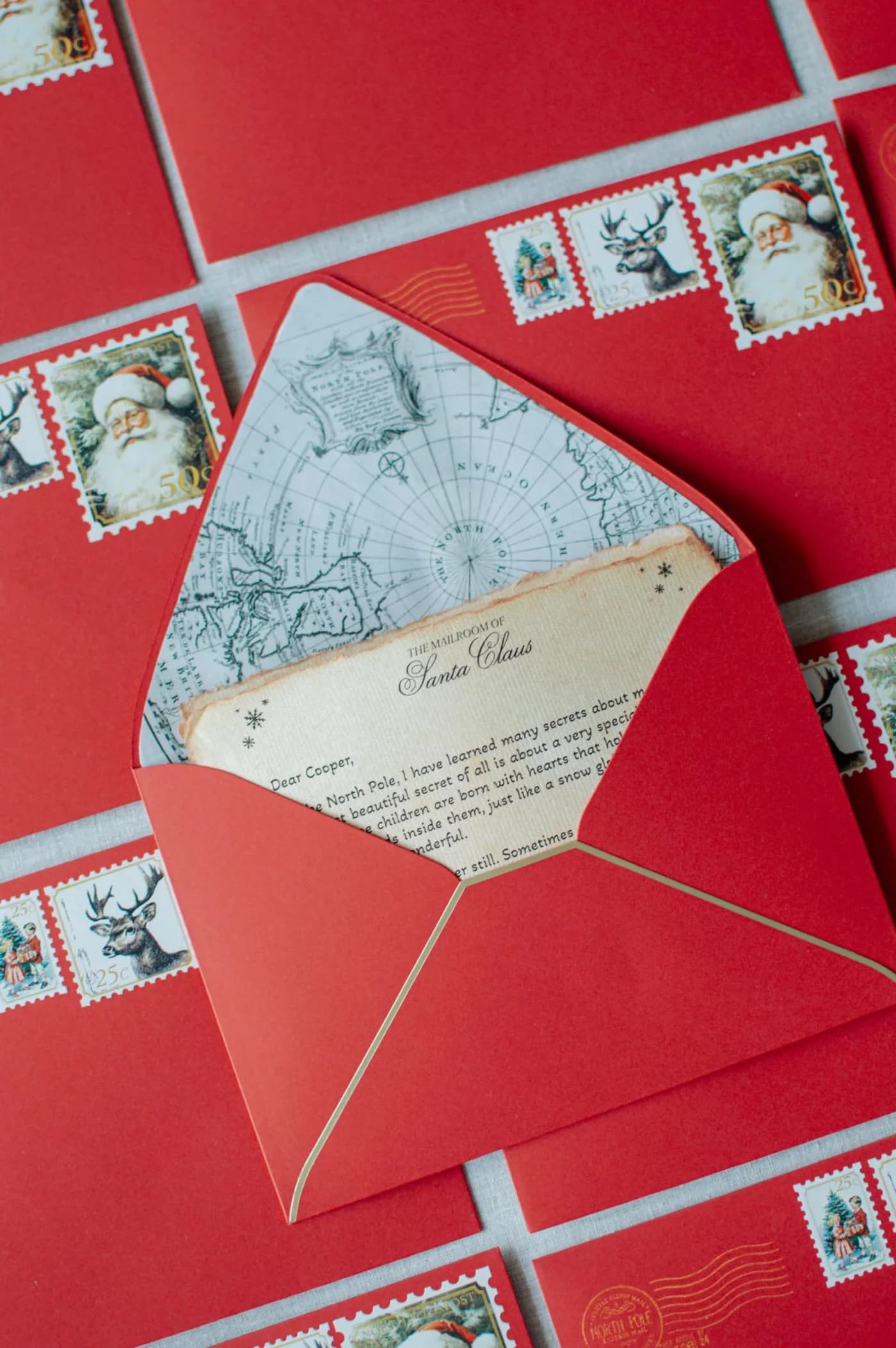 An opened red envelope showing its illustrated lining and a letter tucked inside
