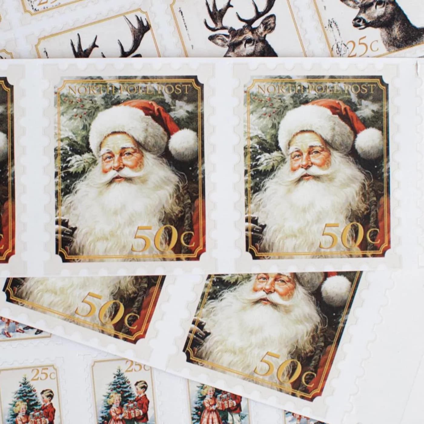 Close-up of printed Santa portrait and reindeer stamp designs